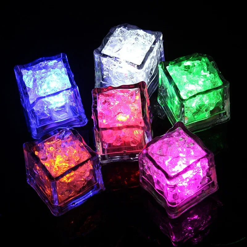 Set of six waterproof LED glowing ice cube lights from Showlu Smart General, liquid sensor drink mood cubes in clear plastic.