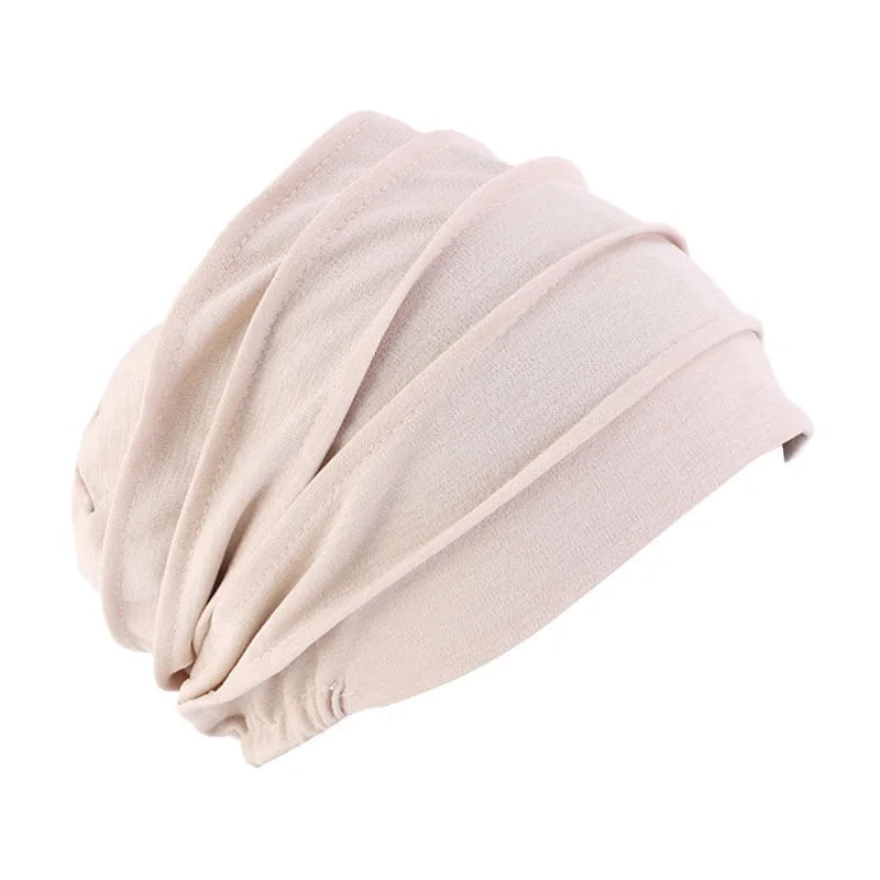 Women’s solid color turban chemo hat with elastic headband, ideal for hair loss, cancer wigs, and Muslim hijab styling.