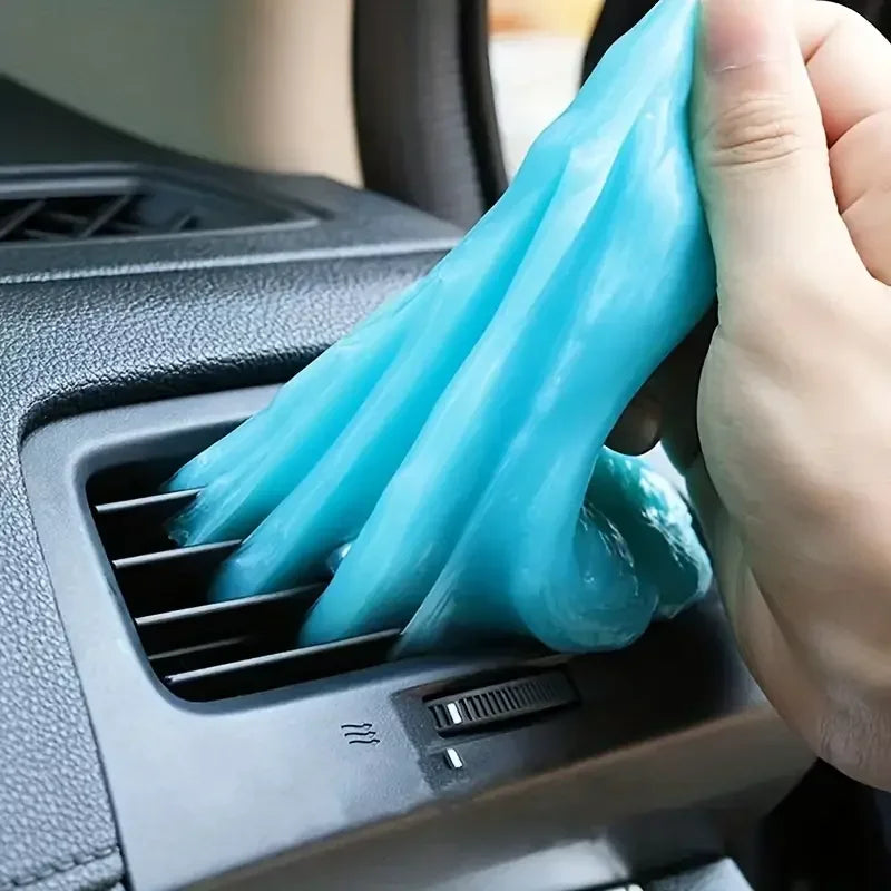 Showlu Smart General car cleaning gel being used to remove dirt and dust from vehicle interior surfaces.