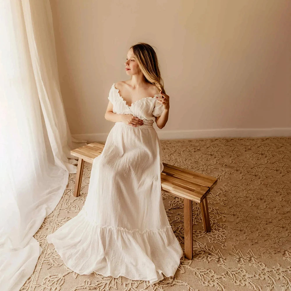 Showlu Bohemian maternity maxi gown featuring off-shoulder ruffled design, perfect for maternity photoshoots and special occasions.