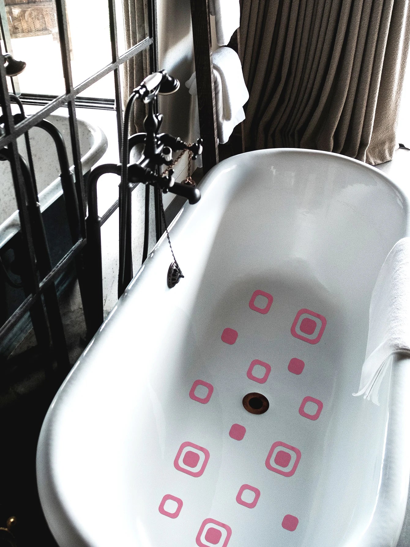 Showlu Smart General anti-slip bath stickers on a bathroom floor, providing safety and grip in wet conditions.
