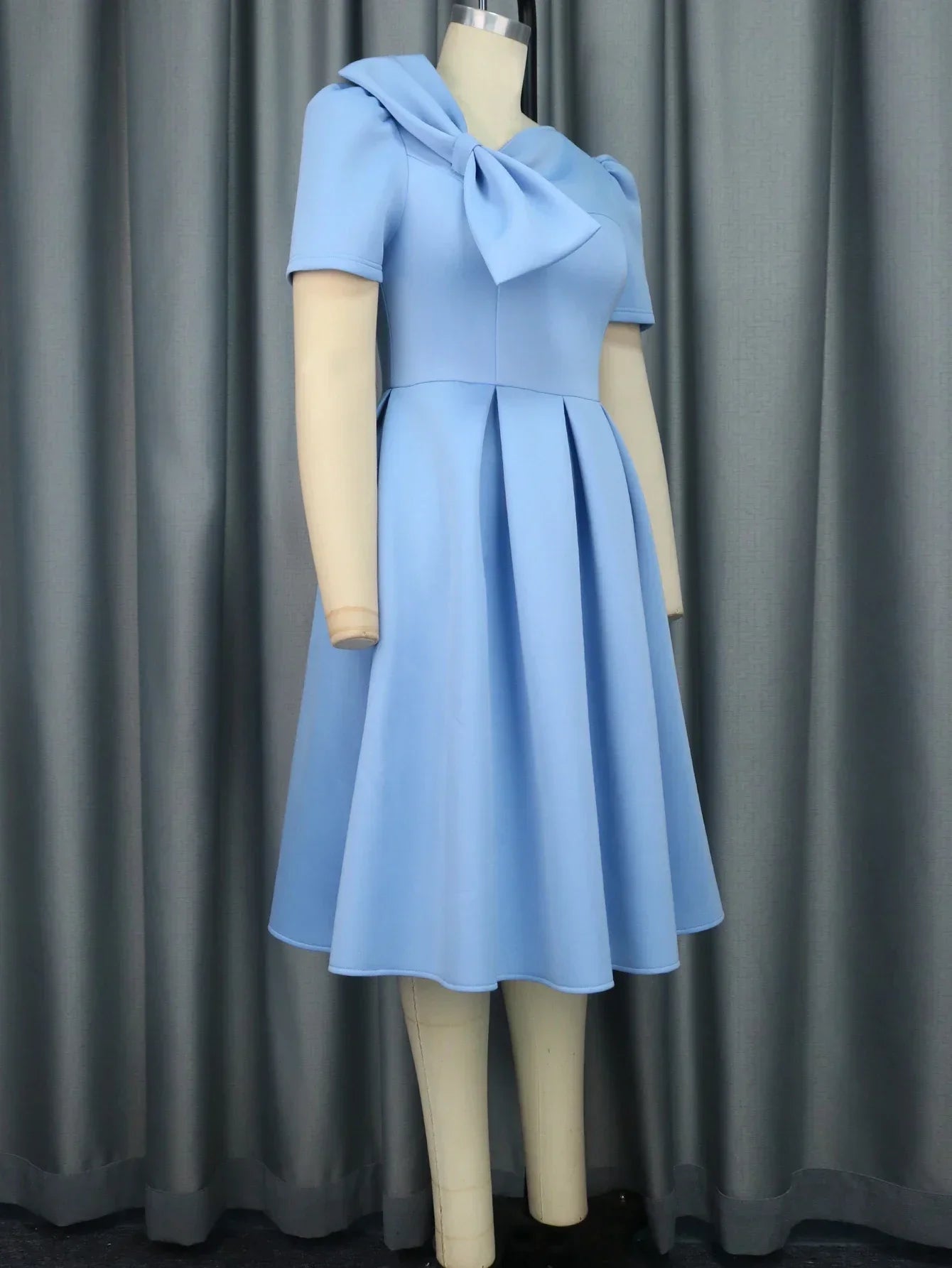 Plus size AOMEI women's pleated fit and flare prom dress with bowtie, stylish party dress in vibrant fabric.