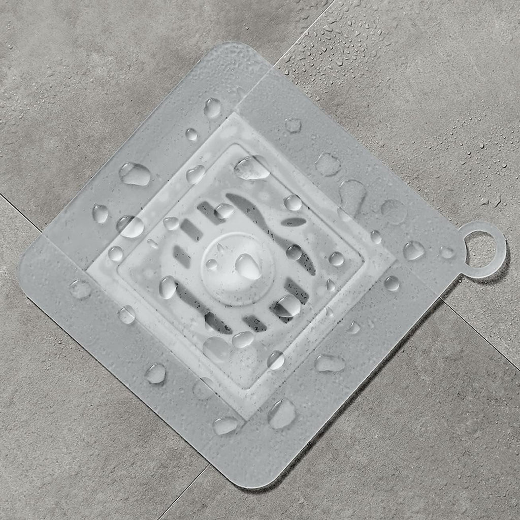 Showlu Smart General silicone drain stopper fitting into a kitchen sink to prevent water from draining.