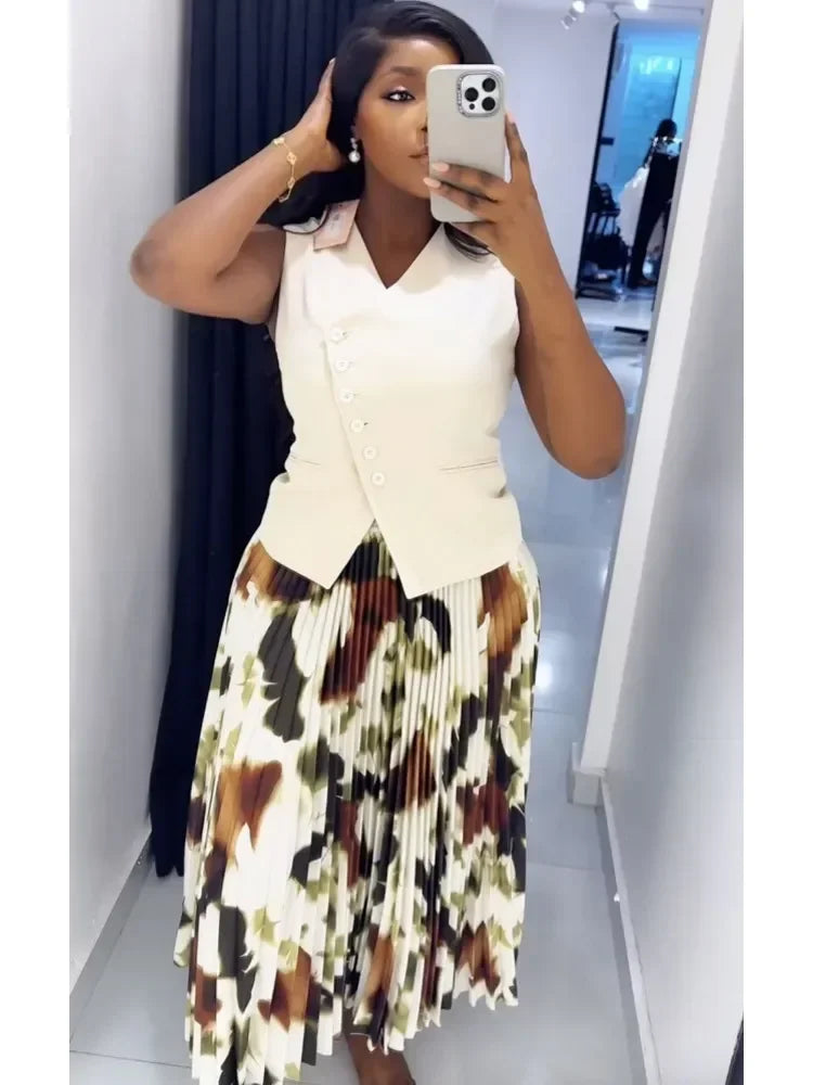 Two-piece women's outfit with African dashiki top and pleated skirt, traditional Ankara style for wedding or party wear.