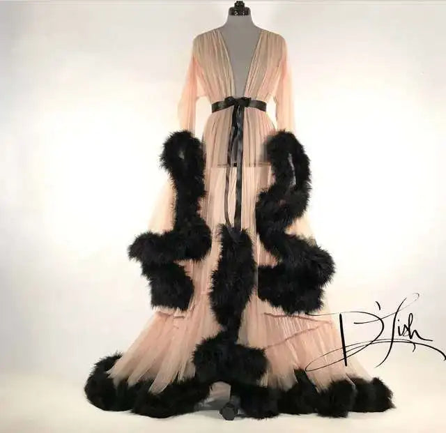 Deep V-neck tulle maternity dress with lace details, long sleeves, feather accents, ideal for photo shoots and special occasions.
