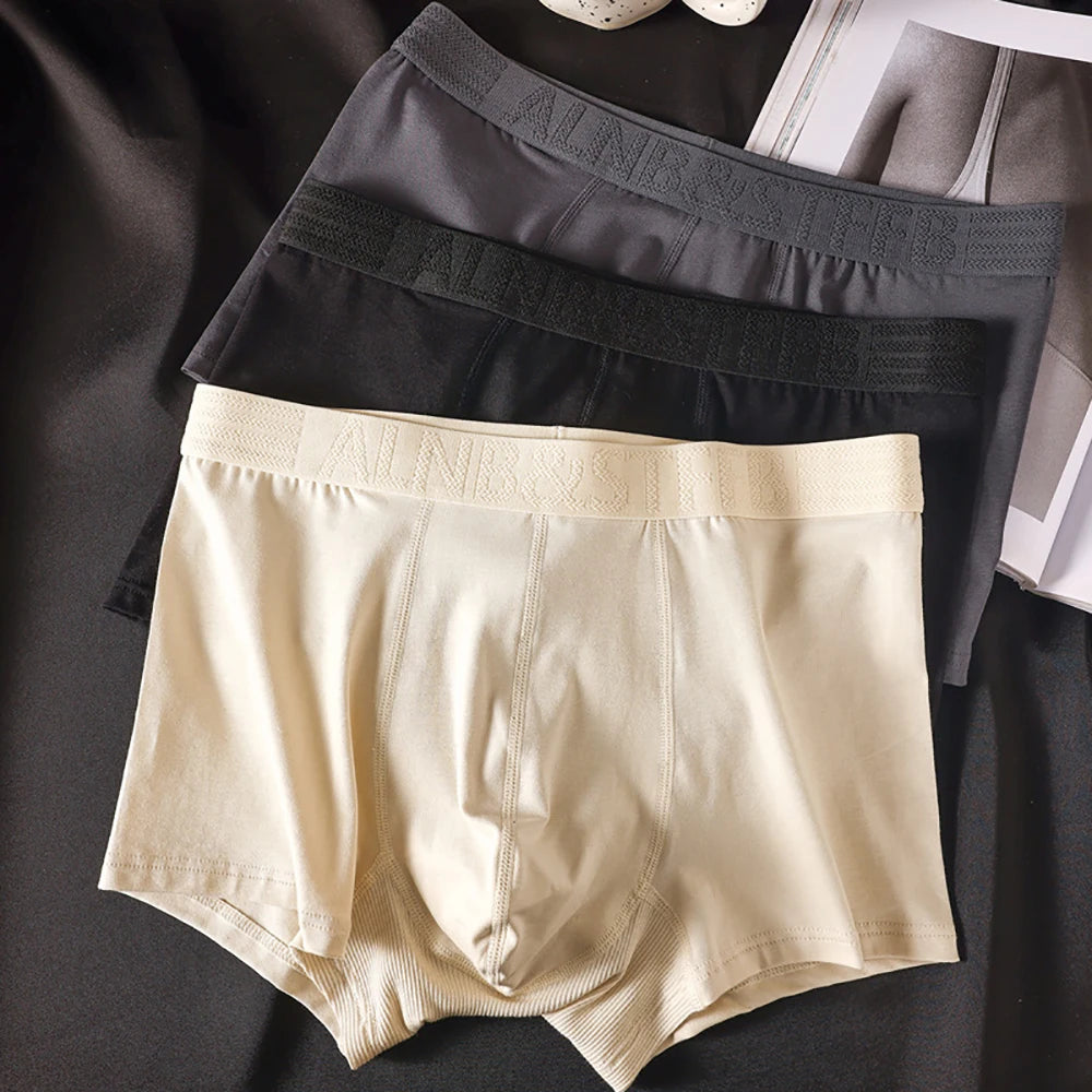Three pairs of Showlu Fashion men's cotton antibacterial boxer briefs with breathable double-layer U pouch and hygroscopic fabric.