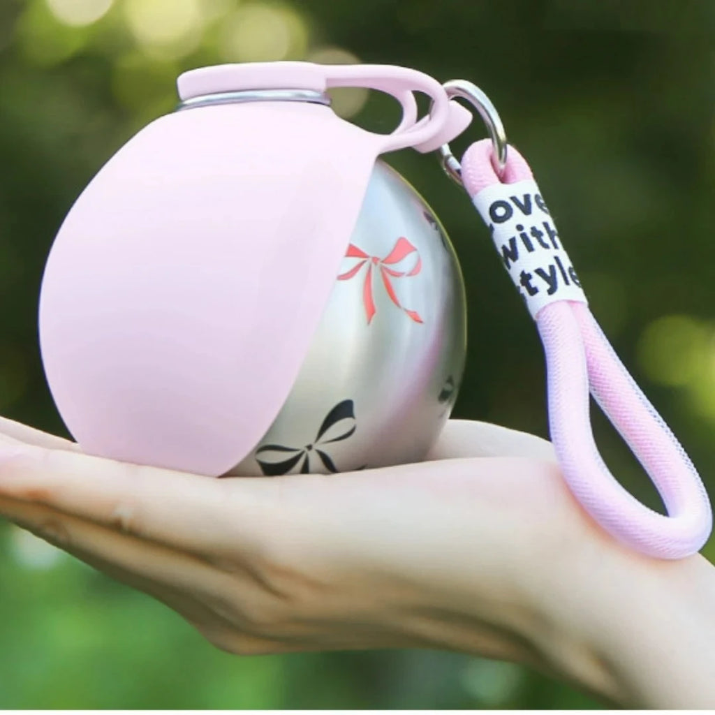 Showlu 2-in-1 portable dog water bottle with stainless steel leak-proof cup, ideal for outdoor dog hydration.