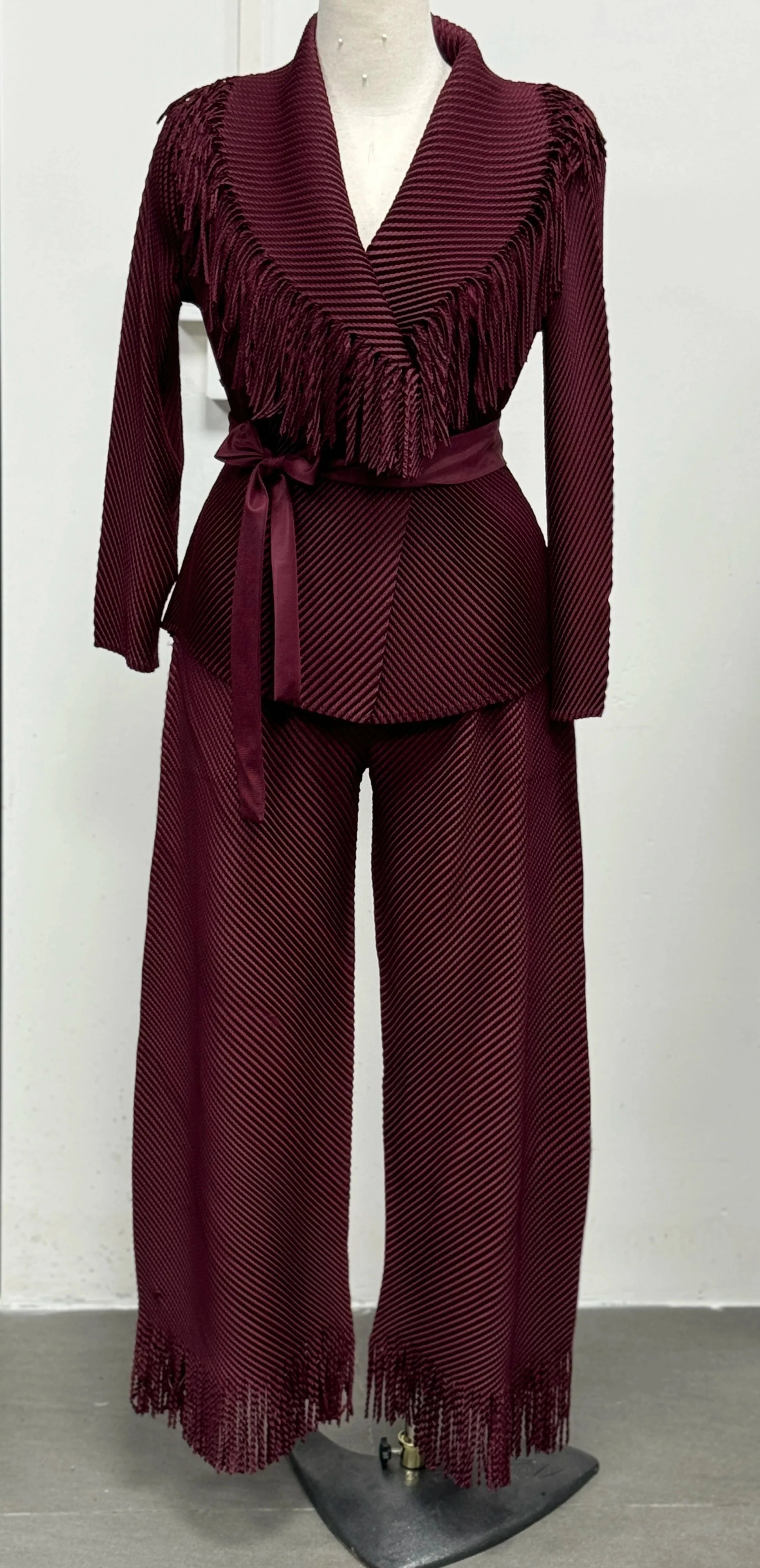 Miyake Folds women's fringe lapel coat and straight skirt two-piece set, stylish fashion ensemble with textured fabric and modern design.