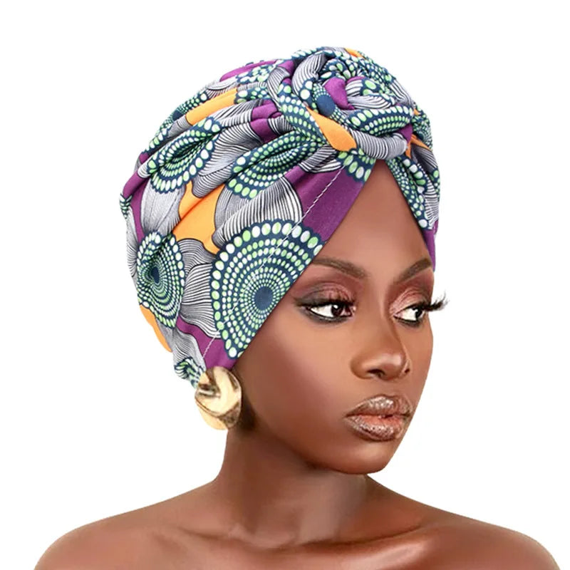 Elegant African print pleated turban with floral design, pre-tied front knot, elastic band, and bandana style headwear for women.