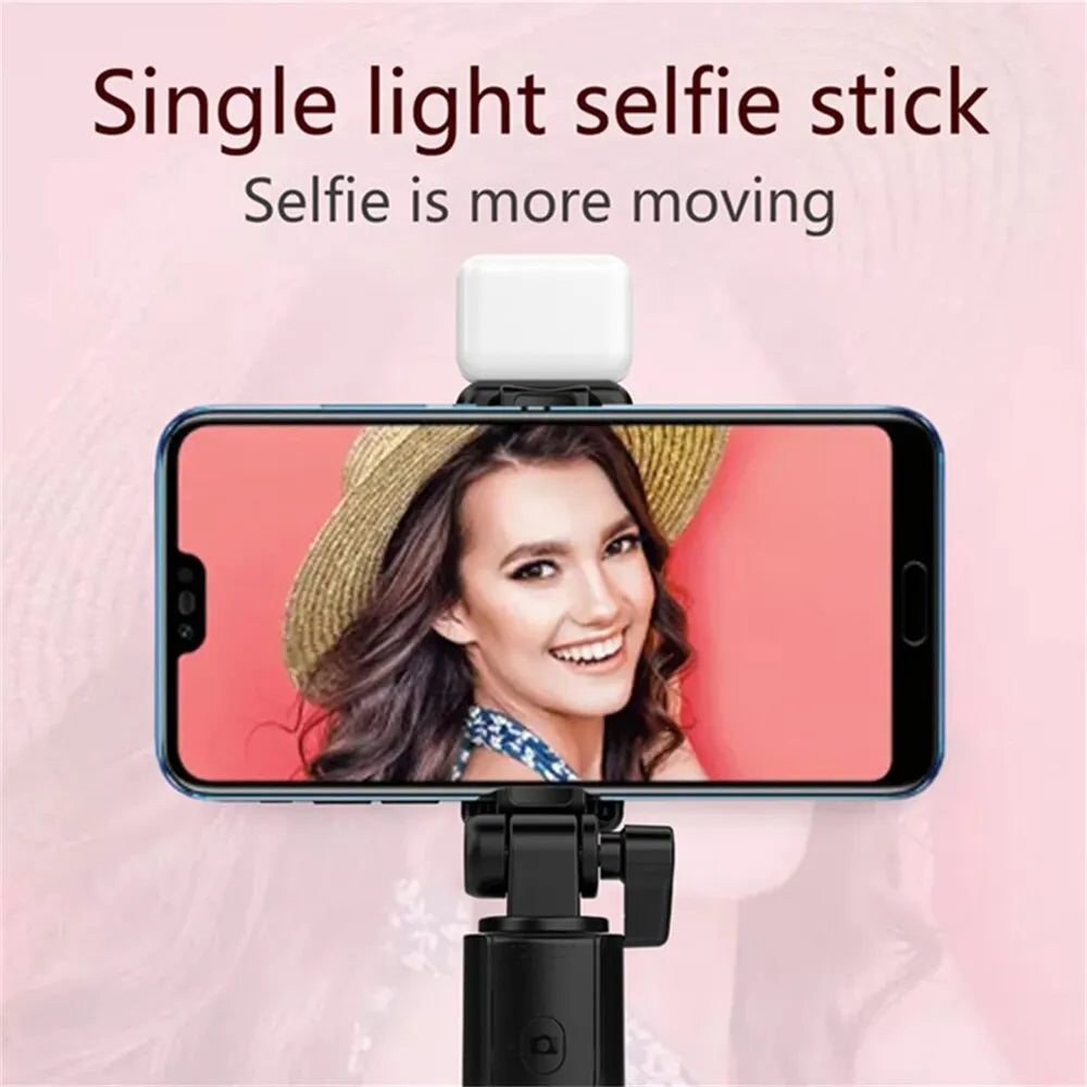 Wireless selfie stick tripod with Bluetooth remote, phone holder, and LED fill light for live streaming and photos.