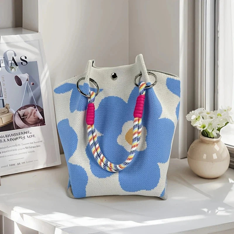 Women's vintage floral knit tote bag with adjustable straps, metal rings, and snap closure, perfect for casual travel and storage.