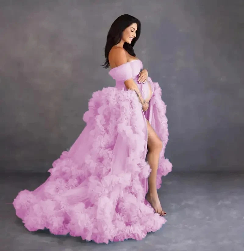 Elegant deep V-neck tulle maternity dress with lace, long sleeves, feather detailing, and trailing design for photoshoots.