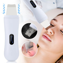 A white ultrasonic skin scrubber with a digital display and metal spatula head.