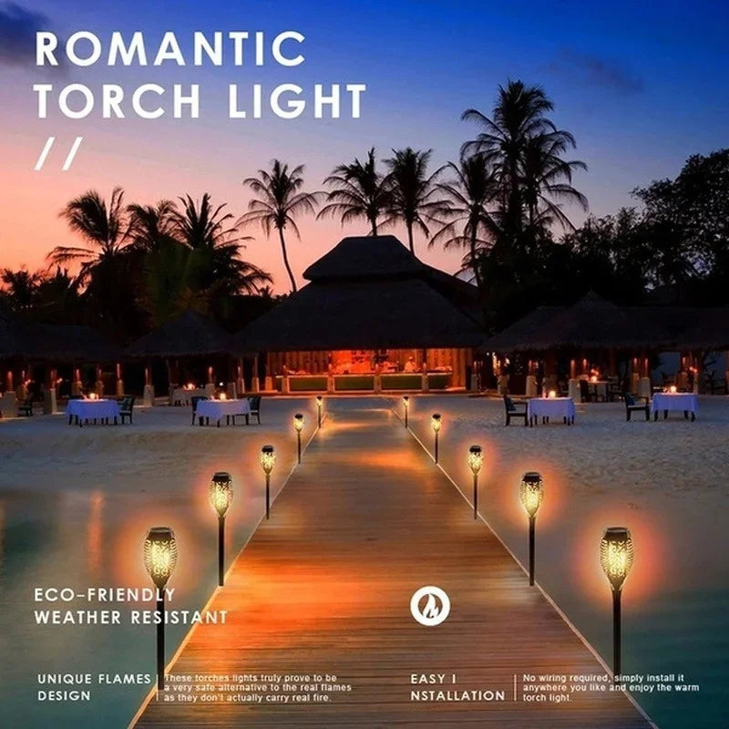 Solar Dancing Flame LED Garden Lantern by Showlu Smart General glowing with flickering flame effect in a garden setting