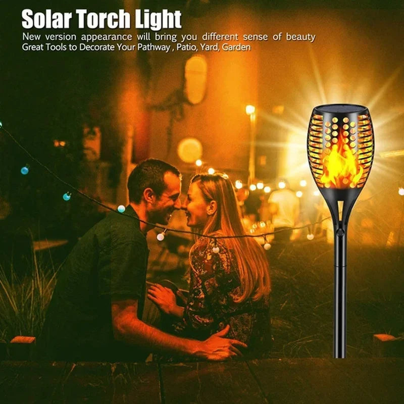 Solar Dancing Flame LED Garden Lantern by Showlu Smart General with flickering flame effect in outdoor garden setting