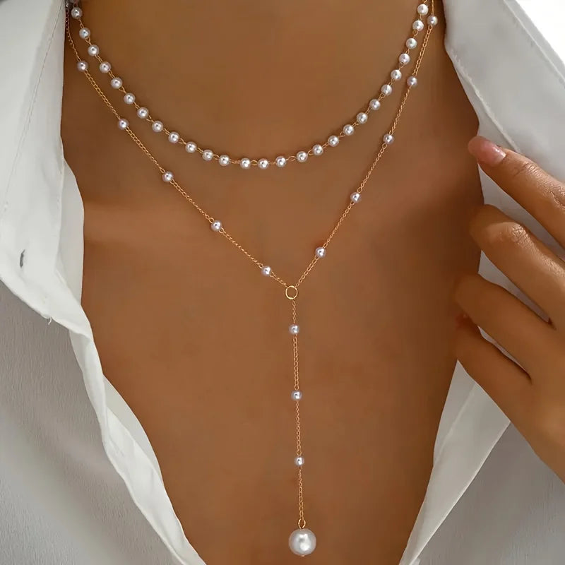 Elegant imitation pearl necklace with long tassel pendant, front chest chain design, women's body jewelry by Showlu Fashion.
