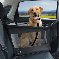 A medium-sized dog sits inside a black, mesh-sided portable pet carrier secured on a car seat.