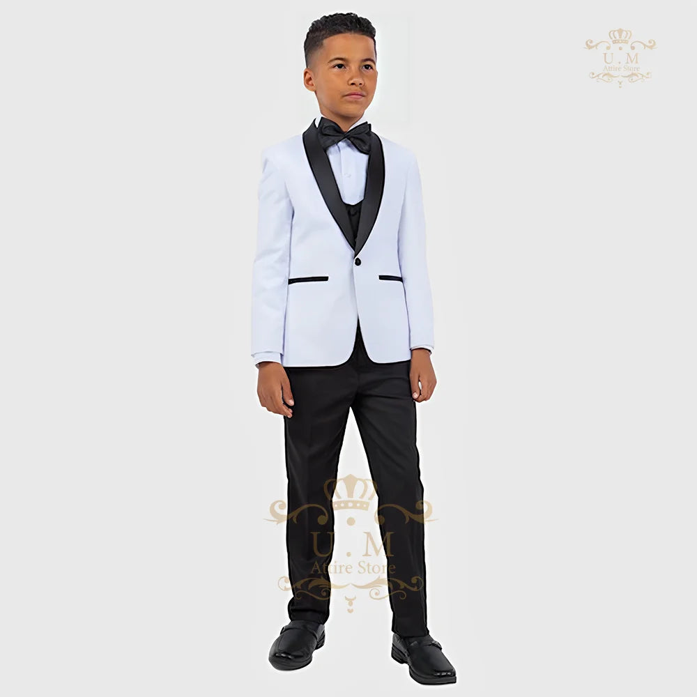 Boy wearing a white tuxedo jacket, vest, and pants from the ZHIO Boys' 3-Piece Formal Suit by SHOWLU FASHION STORE.