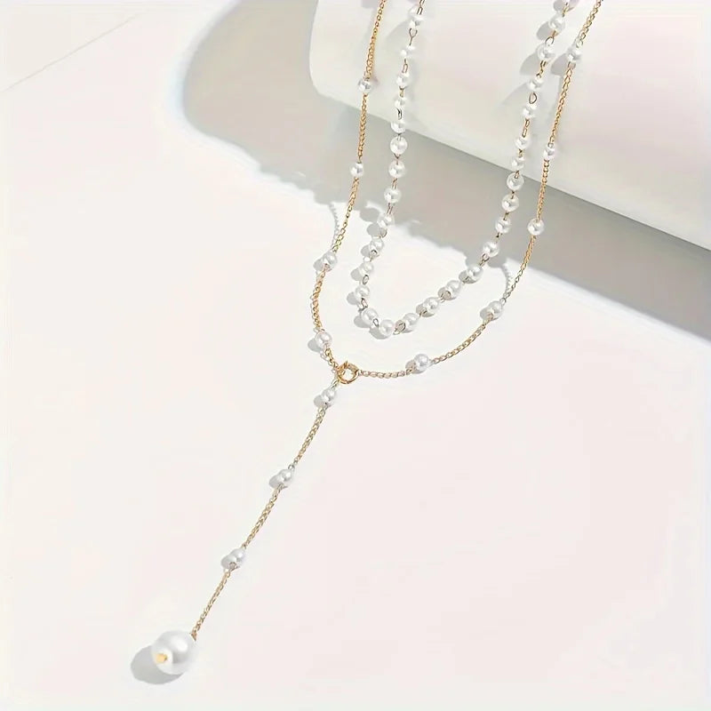 Elegant imitation pearl necklace with long tassel pendant, front chest chain design, suitable as stylish women's body jewelry.
