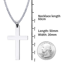 A silver stainless steel cross pendant on a link chain, shown with a ruler and a US quarter coin.