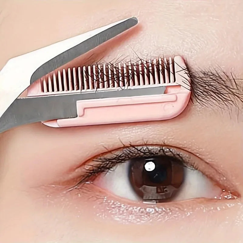 Pink stainless steel eyebrow trimming scissors with built-in comb for precise grooming and shaping of eyebrows.