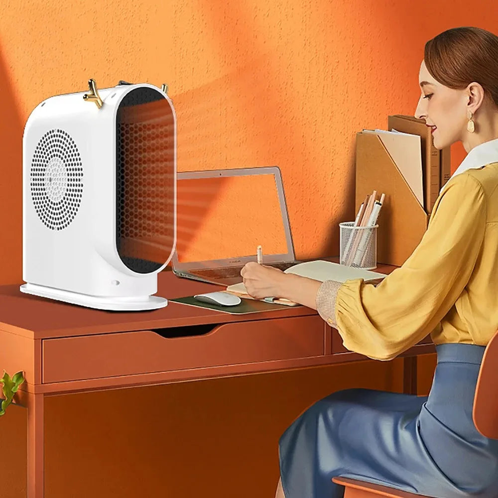 Showlu Smart General portable 500W electric desktop space heater fan on a desk, compact and energy-efficient heating device