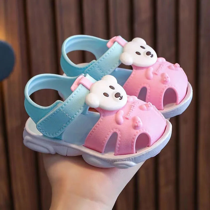 Showlu Baby open-toe clogs with soft soles and anti-slip design, perfect for infant walking shoes, shown in a playful pose.