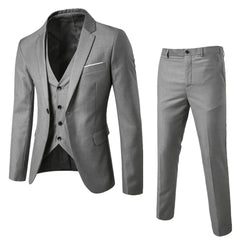 A three-piece slim-fit suit in solid grey, featuring a blazer, vest, and matching trousers.