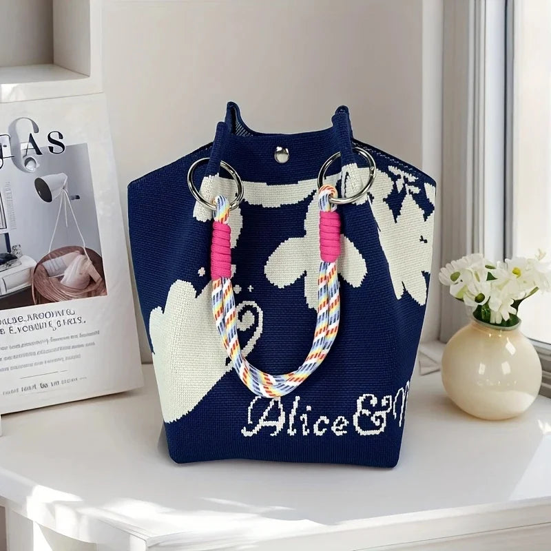 Women's vintage floral knit tote bag with adjustable straps, metal rings, and snap closure, ideal for casual travel and storage.
