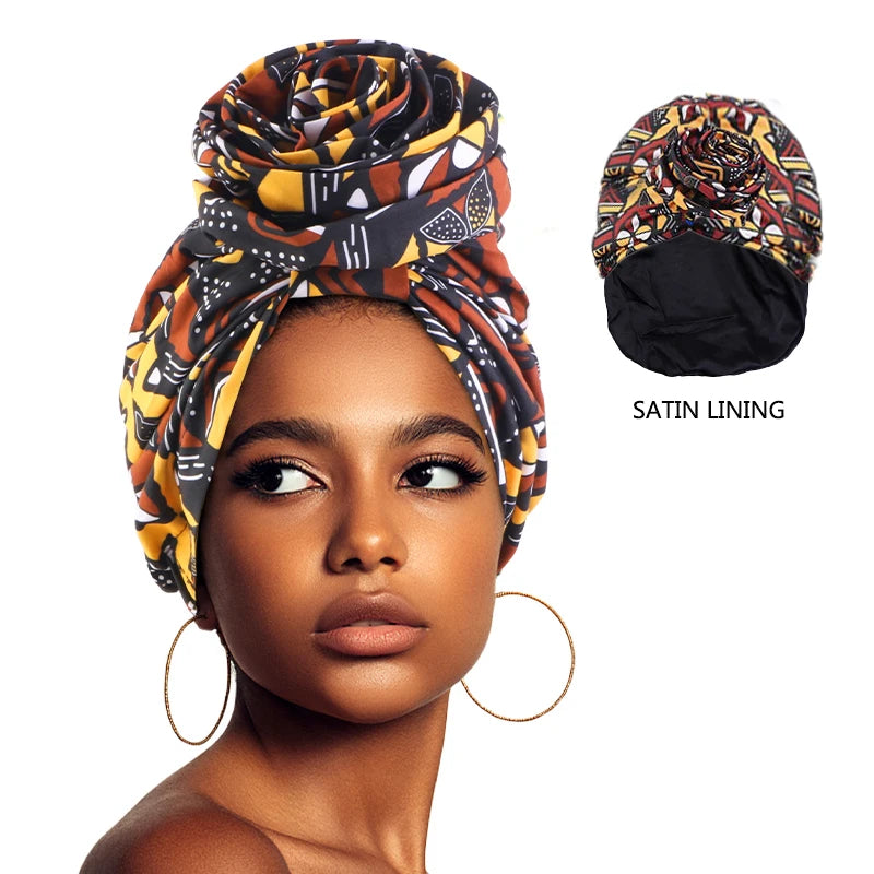 Woman wearing floral printed African satin-lined turban cap with big flower detail, headwrap, and Muslim-style bonnet.