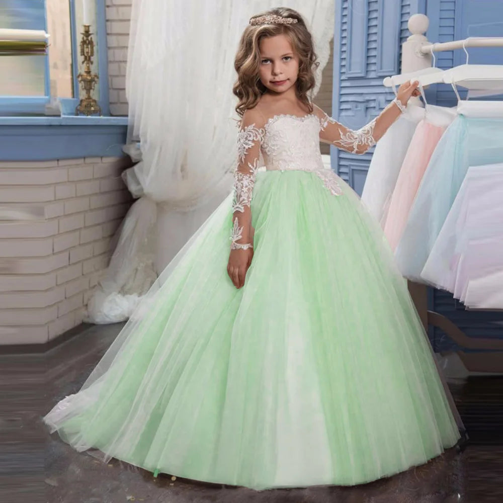 Light pink tulle flower girl dress with white appliques and long sleeves, perfect for weddings, birthdays, and communions.