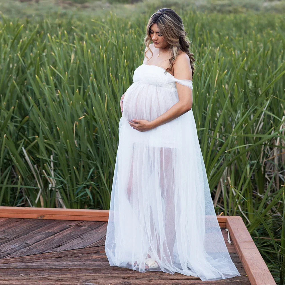 Off-shoulder Showlu Lace Mesh Maternity Gown, a beautiful pregnancy photo dress with elegant lace details and flowing fabric.