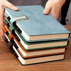 A stack of four A5 leather notebooks in blue, green, brown, and black with matching pen holders.