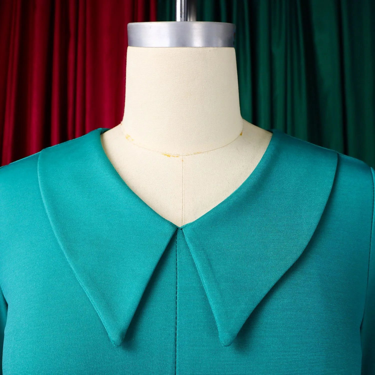 Elegant office dress for women featuring a V-neck, half sleeves, belt, and pleated design, ideal for professional business attire.