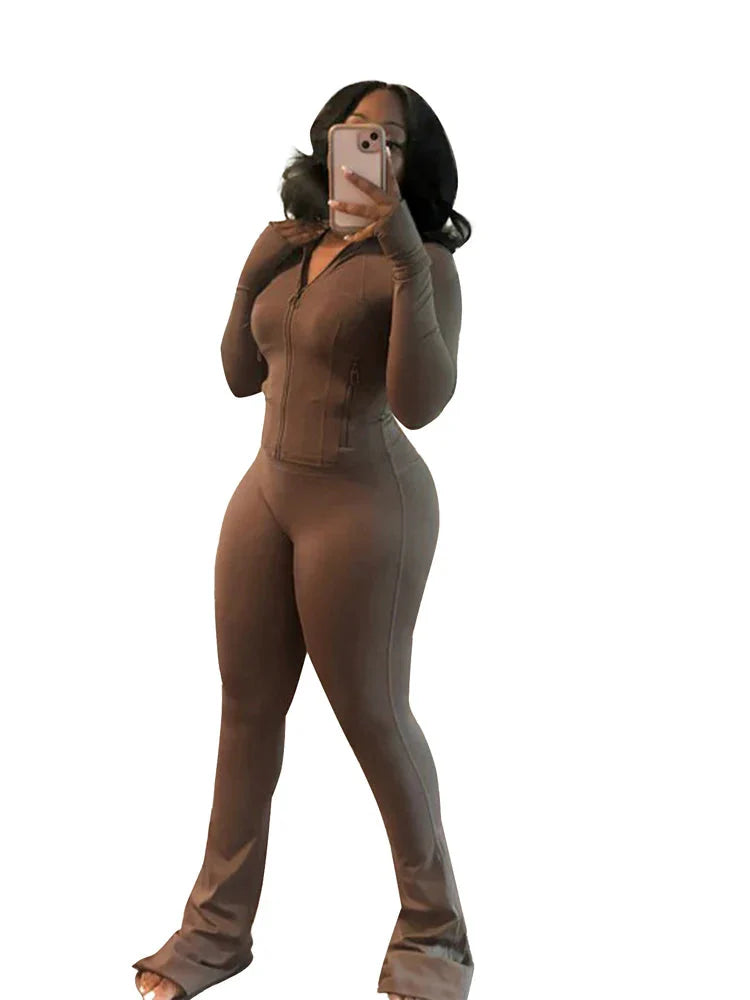 Women's two-piece tracksuit with flared pants and zip-up top by JENYAGE, displayed in a stylish casual outfit.