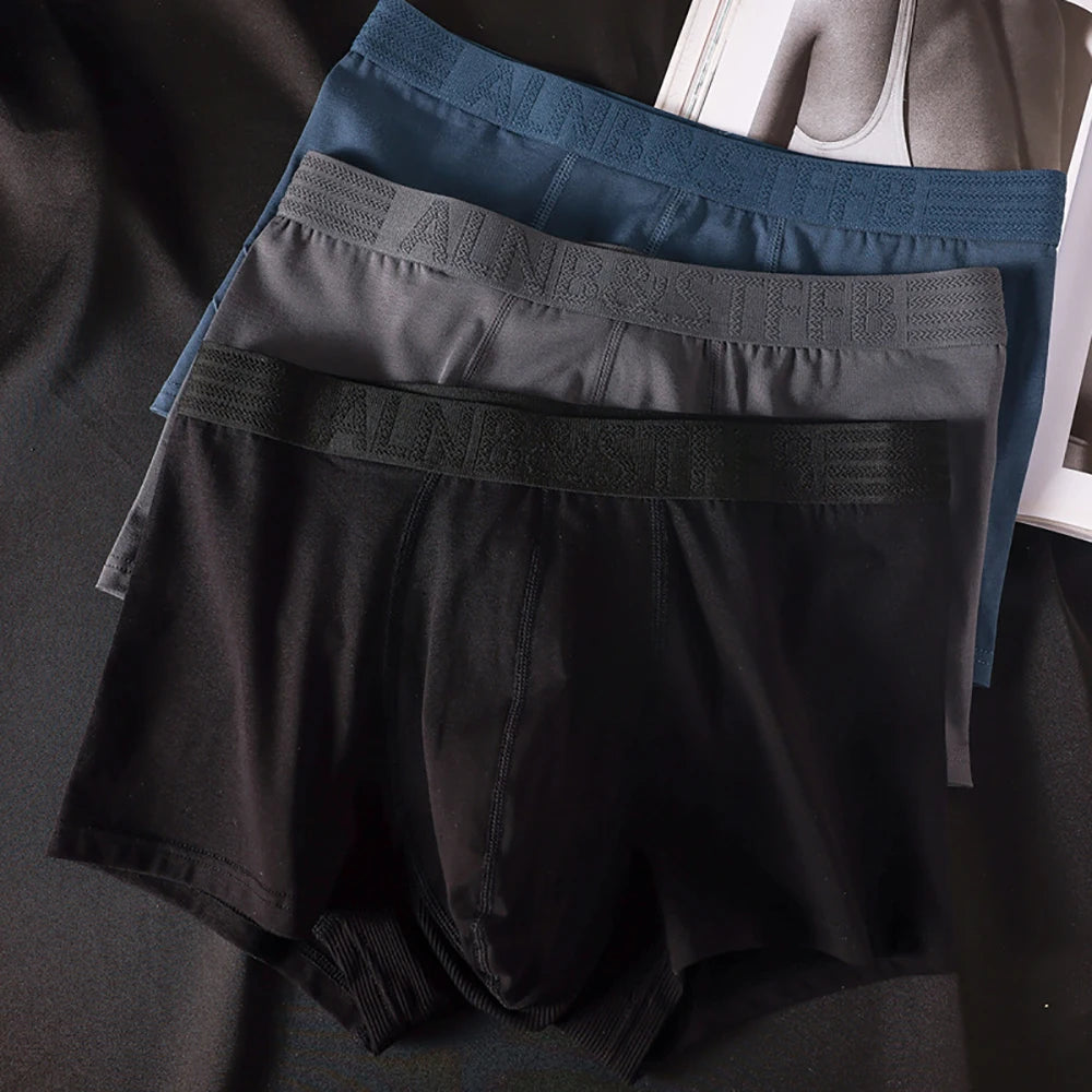 Three pairs of Showlu Fashion men's antibacterial cotton boxers with double-layer breathable U pouch underwear in a pack.