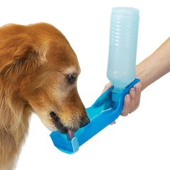 A person holds a blue portable pet water bottle with an attached drinking tray for a dog.