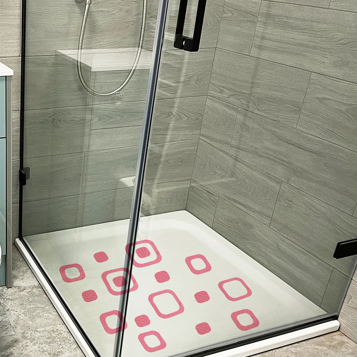 Showlu Smart General anti-slip bath stickers on a tiled bathroom floor, providing safety and traction in wet conditions.