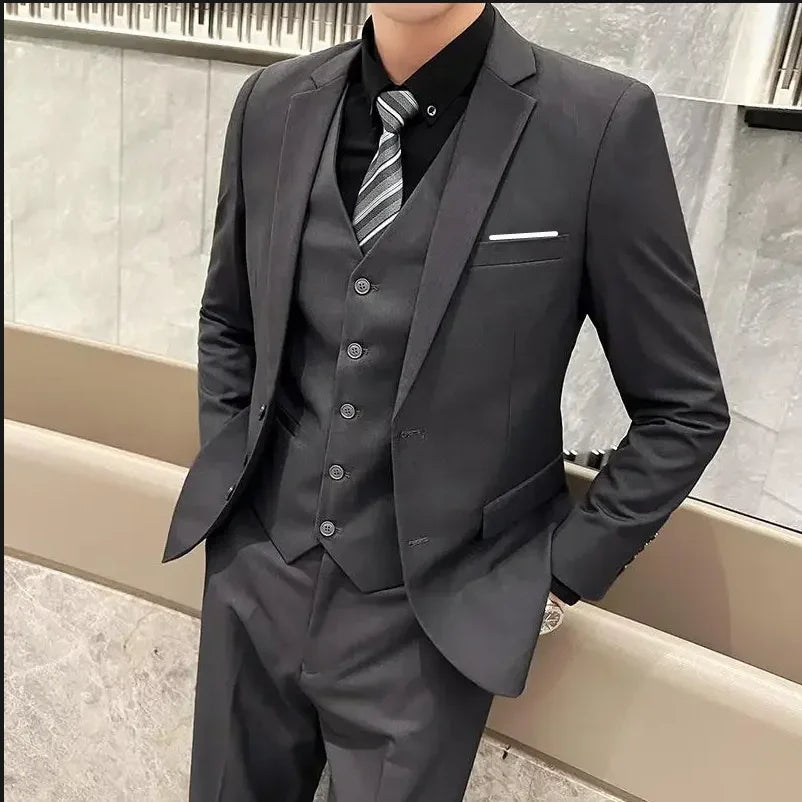 Men's British style suit with blazer, vest, and trousers, perfect for business, casual, or wedding occasions in solid color.