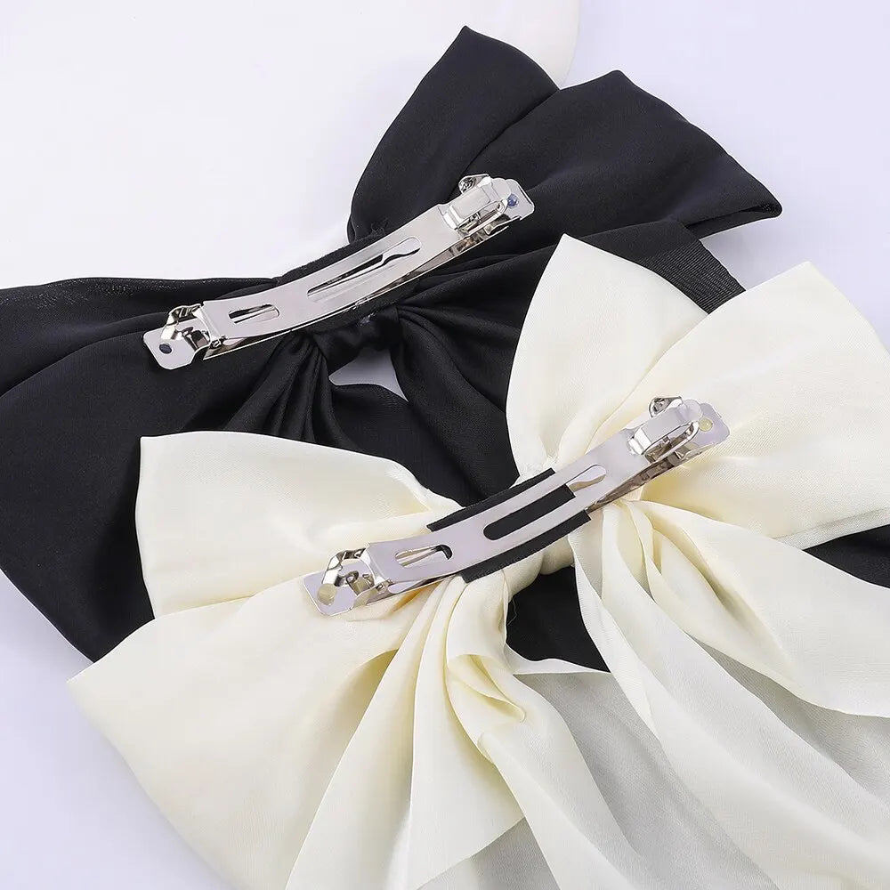 Two elegant bow ribbon hair clips for women, satin bowknot barrettes perfect for ponytails and girls' hair accessories.