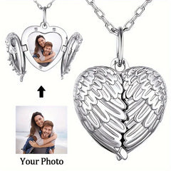 A silver heart-shaped locket necklace with angel wings that open to reveal a custom photo.