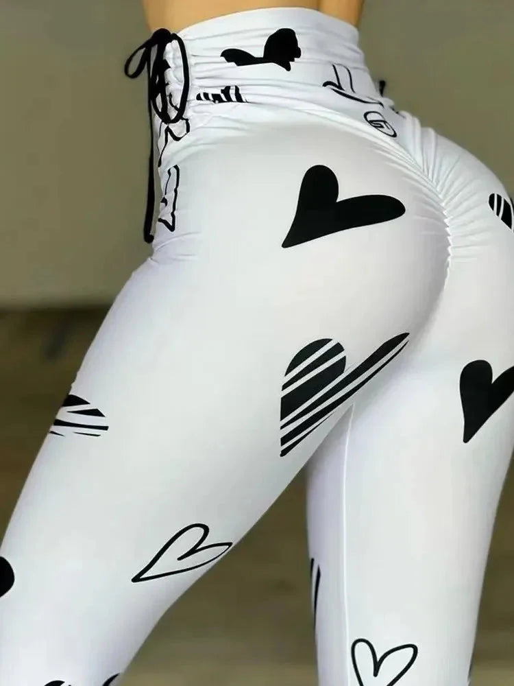 Owner Girl Heart Printed Yoga Leggings by SHOWLU FASHION STORE, featuring a slim fit, heart pattern, and drawstring waistband for sporty comfort.