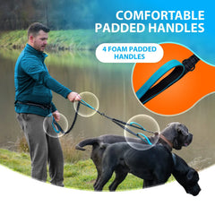 A man walks two dogs using a hands-free double leash featuring four foam-padded handles.