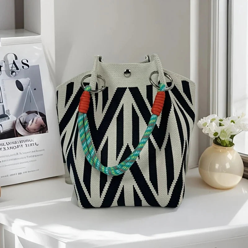 Women's vintage floral knit tote bag with adjustable straps, metal rings, and snap closure, ideal for casual travel and storage