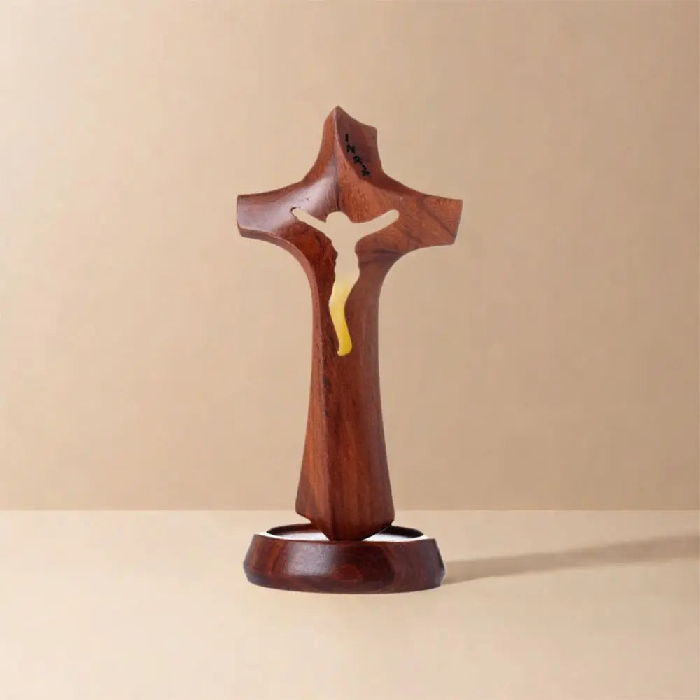 Wooden hollow cross sculpture with a natural finish, standing on a base, vintage-style religious crucifix ornament for desktop display