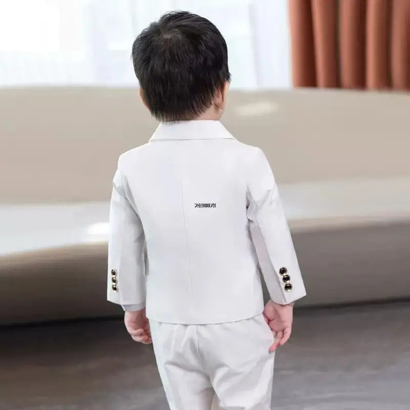 Boy wearing PsyMonster white wedding tuxedo suit with jacket and pants, formal 2-piece set for special occasions