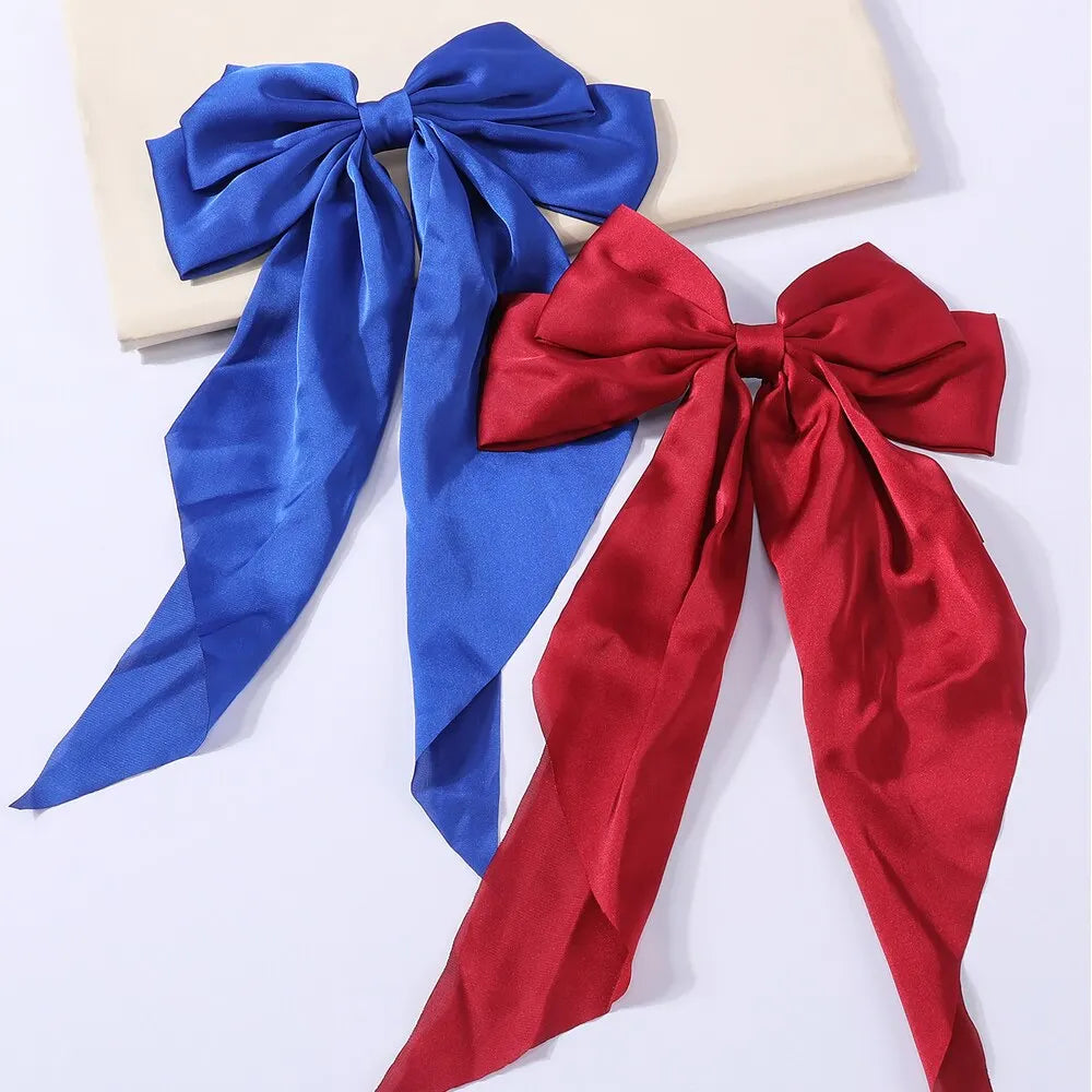 Set of two elegant satin bow hair clips for women and girls, featuring solid bowknot design for stylish ponytails and hair accessories.