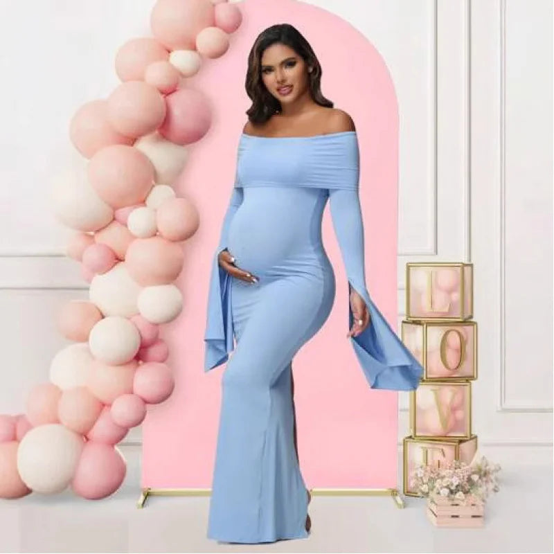 A pregnant woman wears a light blue, off-shoulder, long-sleeve mermaid maternity dress.