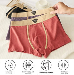 A stack of three men's boxer shorts in red, purple, and black with textured fabric and elastic waistbands.