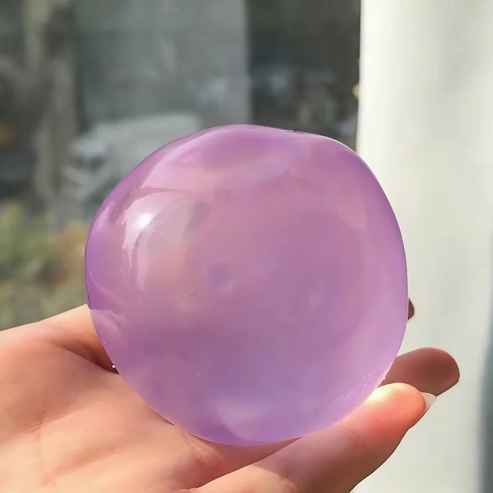 Transparent squishy maltose stress ball by Showlu Fashion Store, soft slow-rise sensory ball for hand exercise and stress relief.